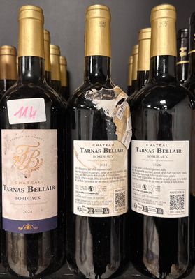 bottles of wine are lined up on a shelf in a store