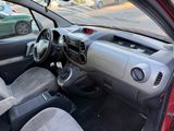 the interior of a small car with a steering wheel and dashboard