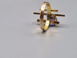 yellow gold ring with a blue sapphire stone