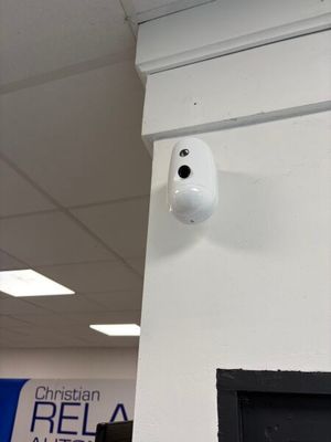 an image of a camera mounted on the wall of a building