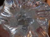 a clear glass vase that has a flower inside of it