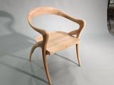 a wooden chair that is sitting on a white surface