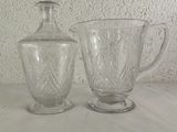 two glass vases sitting next to each other on a table