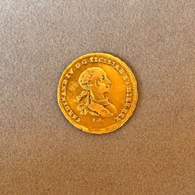 l'image d'une pièce d'or sur laquelle figure l'image d'un homme