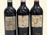 three bottles of wine sitting next to each other on a table