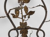 wrought iron candle holder with flowers and leaves on a white background
