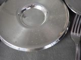 a silver plate with a fork and a knife on it