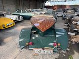 many old cars parked in a garage next to each other