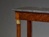 a small table with a marble top on a wooden stand