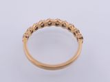 a gold ring with black diamonds on a white background