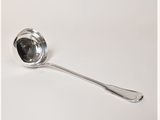 a silver spoon with a spoon handle on a white surface