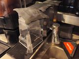 a sink in a kitchen with a lot of clutter on the counter