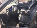 the interior of a car with the door open and the driver ' s seat down