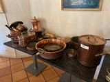 many pots and pans on a table in a room