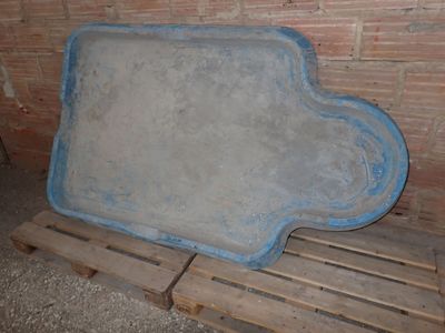 a large cement board on a pallet in front of a brick wall