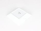 a small white object on a white surface that looks like a square