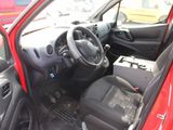 the interior of a small red car with the door open
