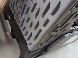 a cat that is standing next to a piece of metal