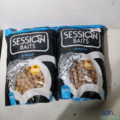 two bags of fish food sitting on top of a counter