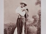 an old photo of a woman dressed in traditional clothing