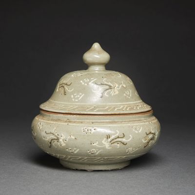 an image of a white vase with a lid sitting on a table