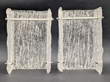 pair of frosted glass bookends with metal rods