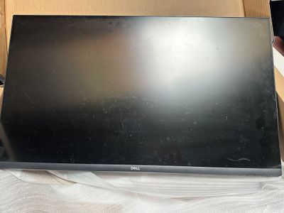 an open laptop computer sitting on top of a cardboard box