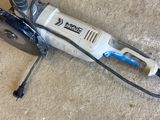 an image of a drill on the ground with a cord