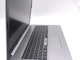 a close up of a laptop computer on a white surface