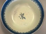 a blue and white plate with a bird on it