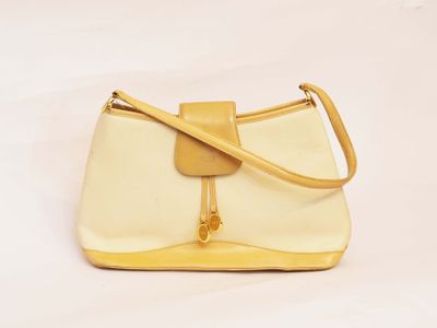 yellow and white handbag on white background