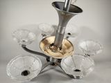 a silver plate with a silver horn on top of it