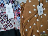 two pairs of women ' s pants with a price tag on them