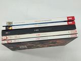 three books stacked on top of each other on a table