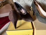 two pairs of women ' s shoes sitting on top of a box next to a mirror