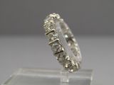 an image of a diamond ring on a clear stand