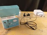 a box of ear buds and a charger on a table