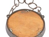 a wooden sign hanging from a chain on a white wall