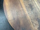 a close up of a wooden table top on a black surface