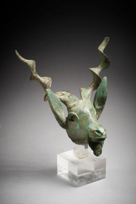 a close up of a sculpture of a deer head on a clear base