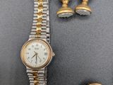 a gold watch and a silver bracelet with a picture of a lady