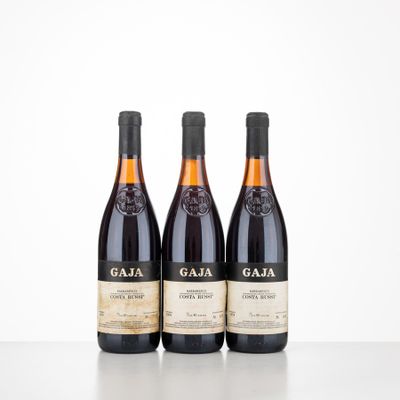 three bottles of wine sitting on top of a table next to each other