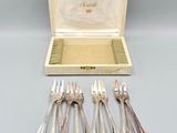 an assortment of silverware including forks, spoons and a box