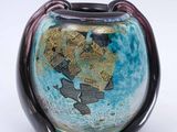 a blue vase with a map on it on a white surface