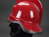 red fireman ' s helmet on a black mannequin head