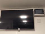 un téléviseur à écran plat fixé au mur d'une pièce
