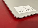 a sticker on the back of a laptop that is on a red table