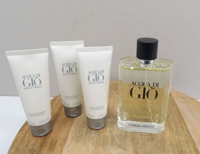 three bottles of perfume sitting on top of a wooden tray
