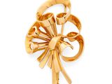 an image of a gold plated brooch with a flower design