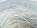 a close up of a blue and yellow bowl on a table